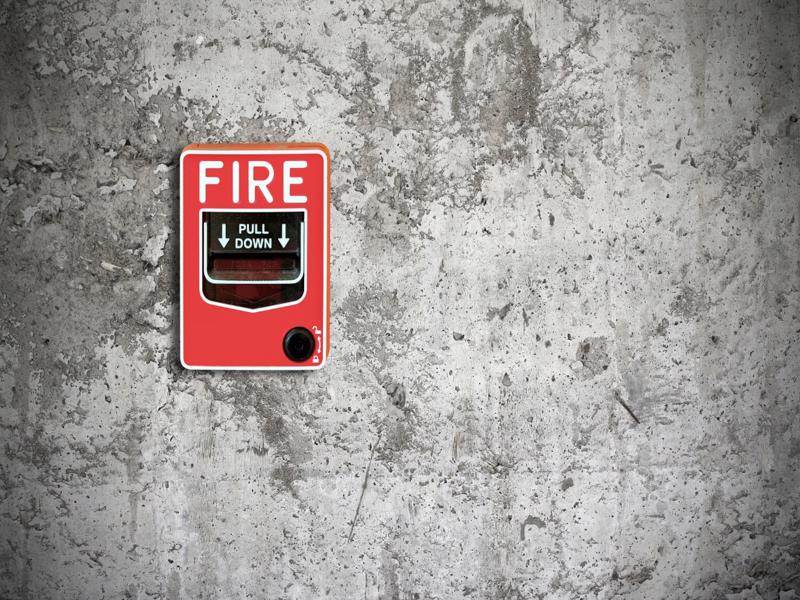 fire break glass on the concrete wall background