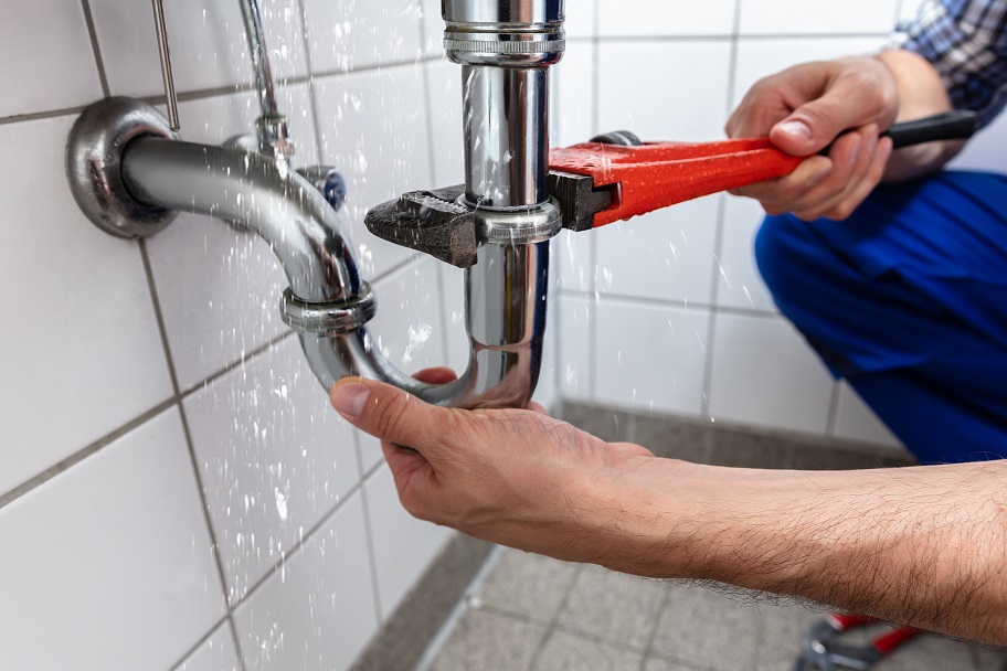 Male Plumber's Hand Repairing Sink Pipe